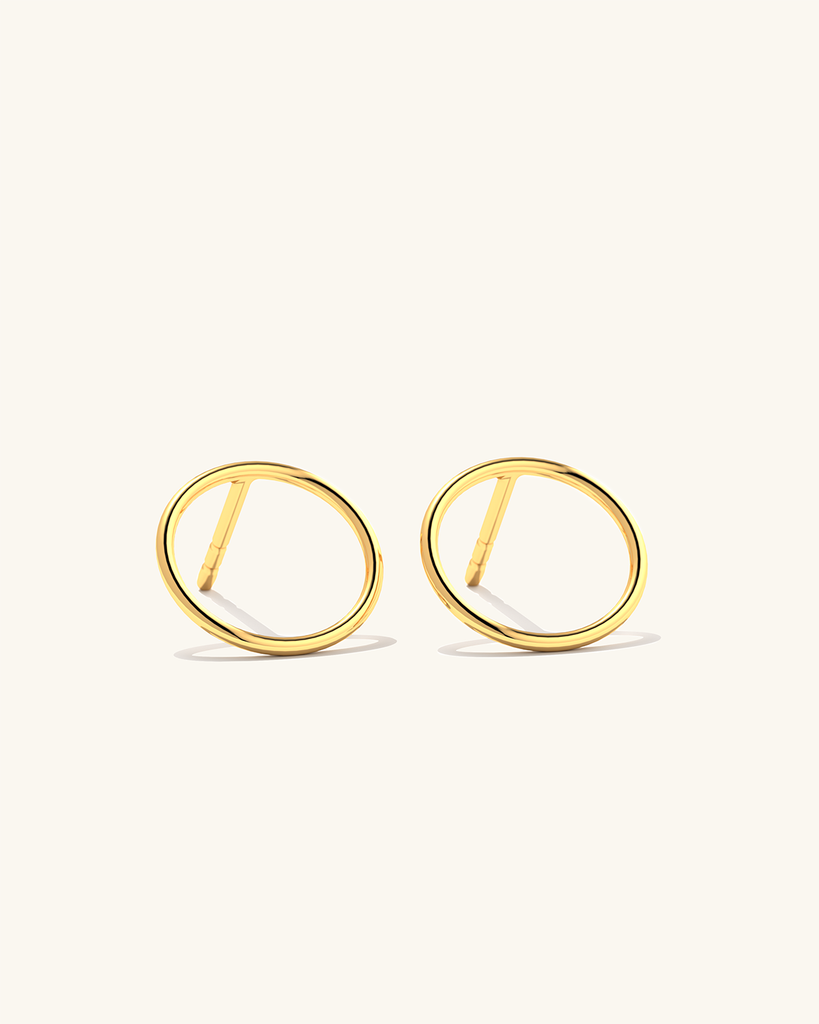 Image of tiny 24k gold vermeil Cici circle stud earrings made of sterling silver, perfect for everyday wear.