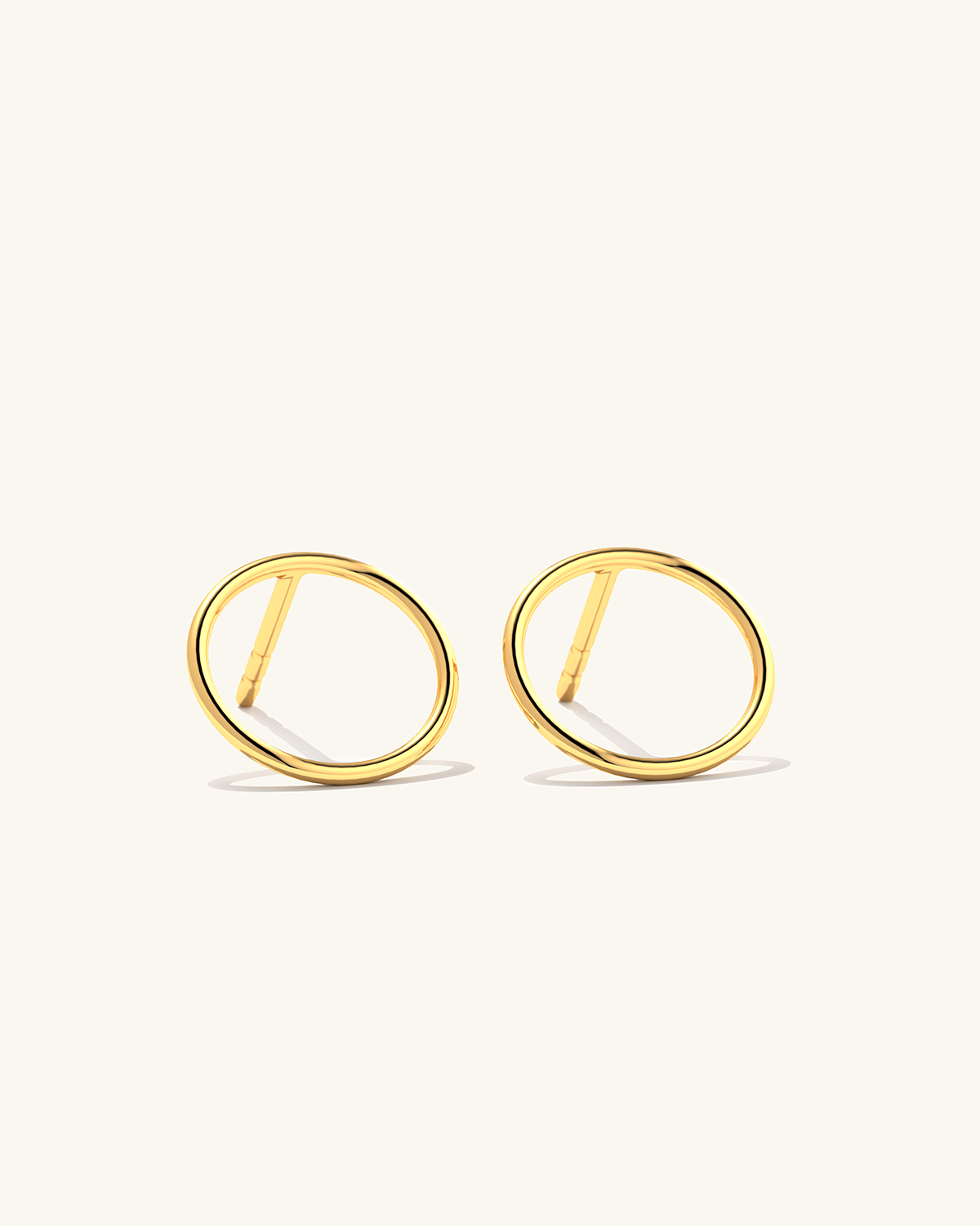Image of tiny 24k gold vermeil Cici circle stud earrings made of sterling silver, perfect for everyday wear.