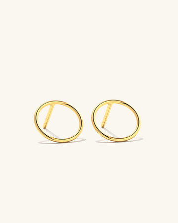 Image of tiny 24k gold vermeil Cici circle stud earrings made of sterling silver, perfect for everyday wear.