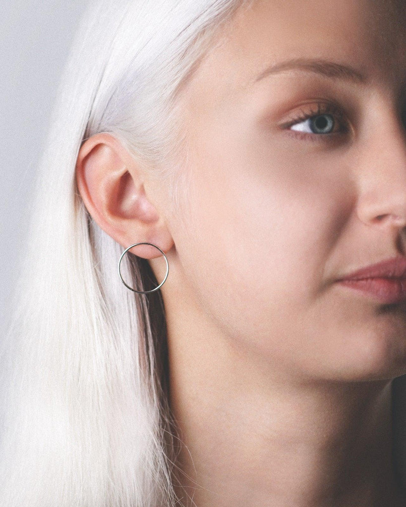 Model showcasing the stunning platinum vermeil cici hoop earring studs for a fashionable and chic appearance.