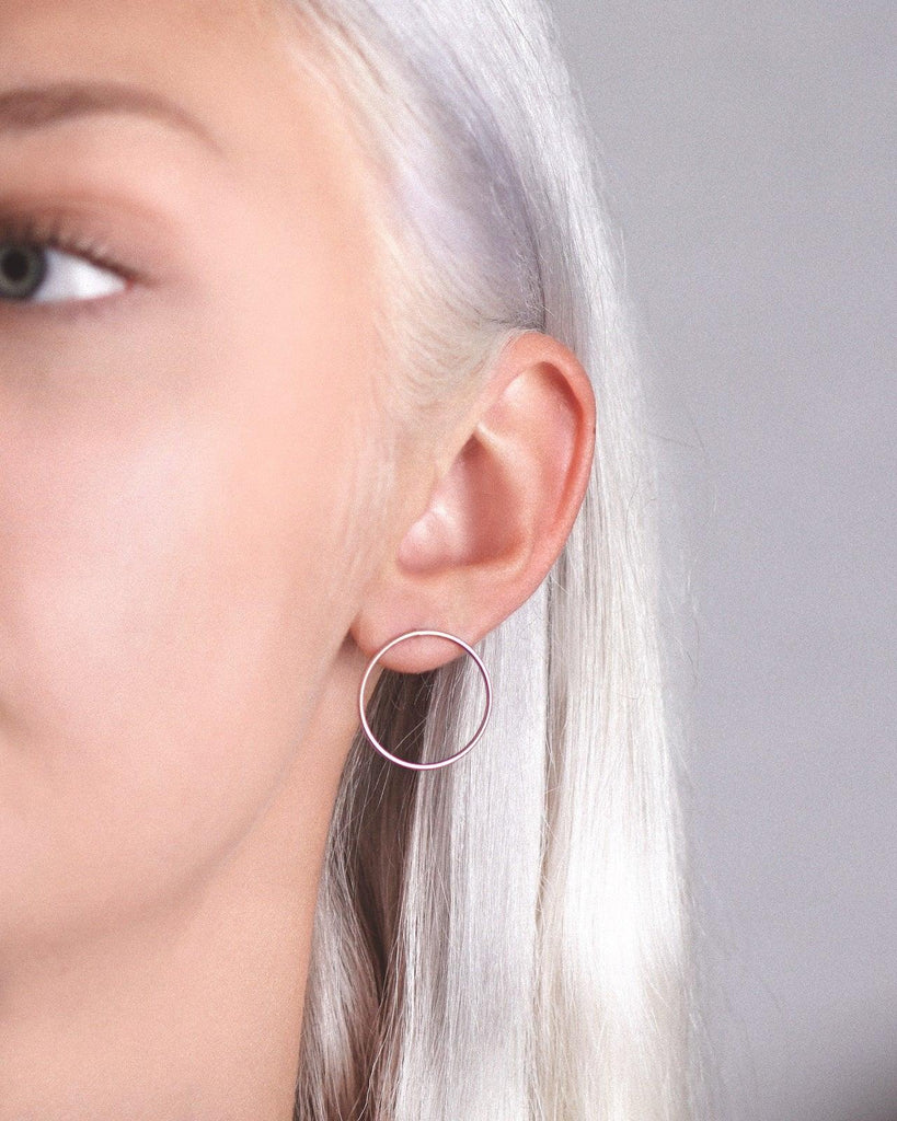 Model showcasing the stunning rose gold vermeil cici hoop earring studs for a fashionable and chic appearance.